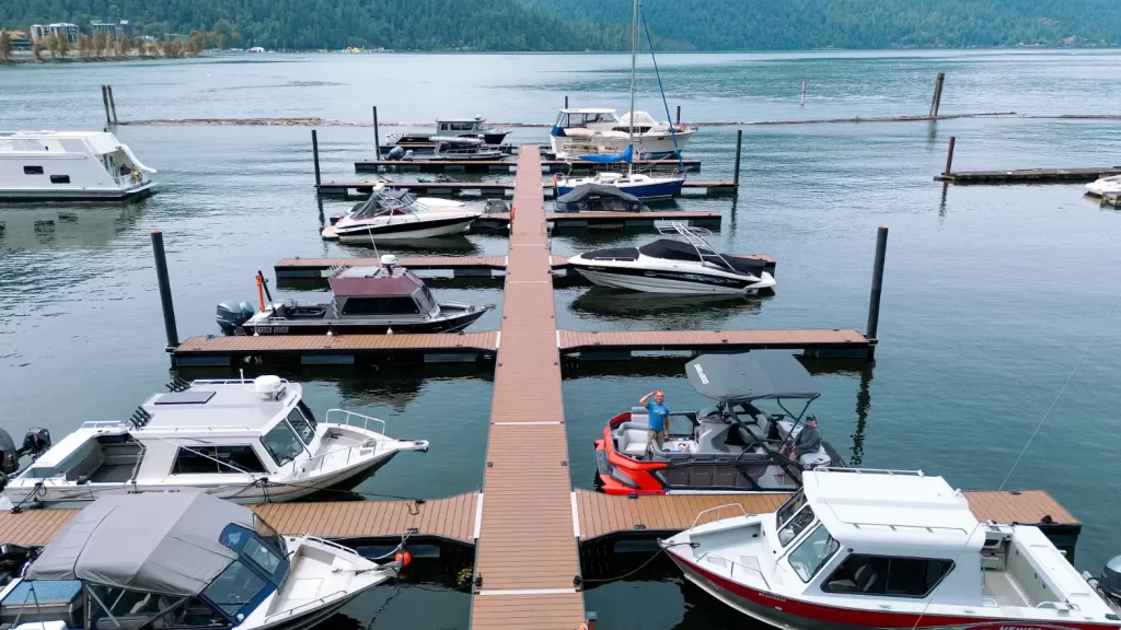 An overhead view of the second new dock at Harrison Hot Springs Marina on Harrison Lake. Different boats are tied to the dock.