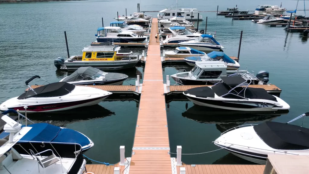 An overhead view of the first new dock at Harrison Hot Springs Marina on Harrison Lake. Different boats are tied to the dock.