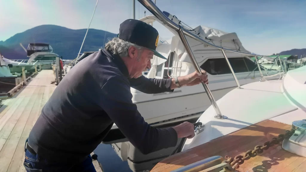 A worker at Harrison Hot Springs Marina tying a boat to the dock.