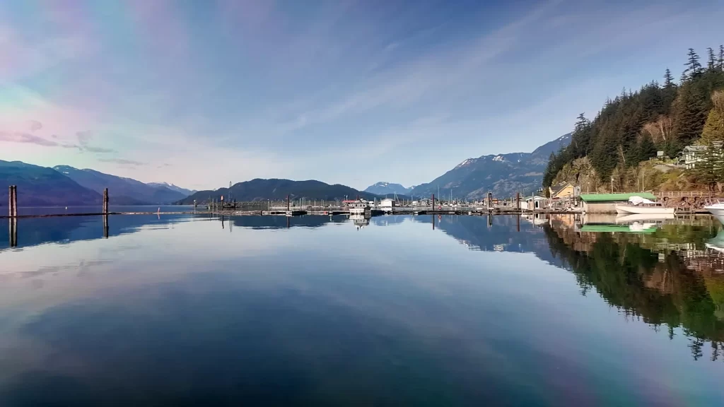 A photo of Harrison Lake taken from Harrison Hot Springs Marina, facing north. You can see the distant mountains that surround the lake.
